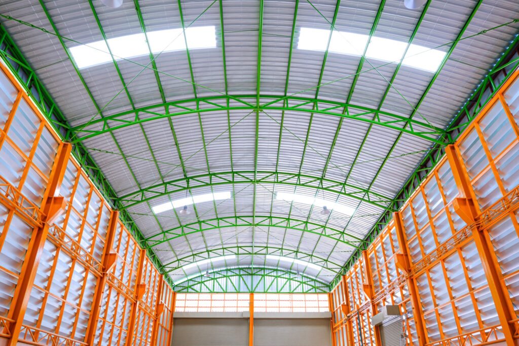 Aluminum louver wall with metal roof structure inside of large modern industrial building