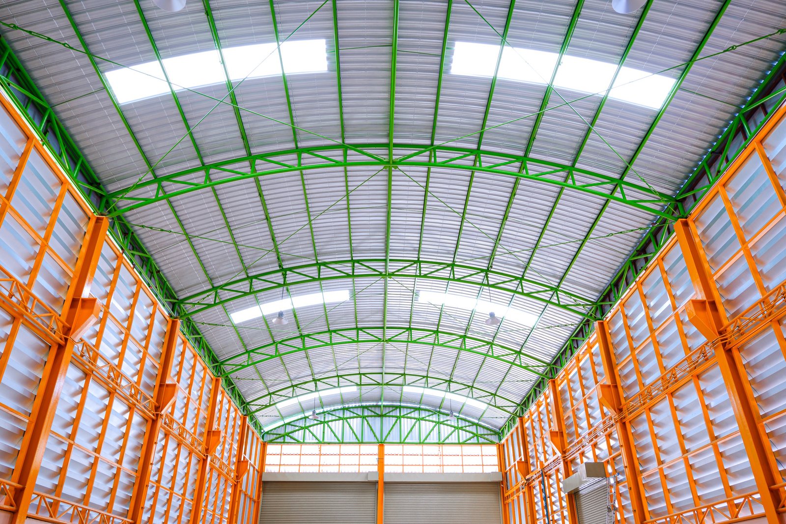 Aluminum louver wall with metal roof structure inside of large modern industrial building